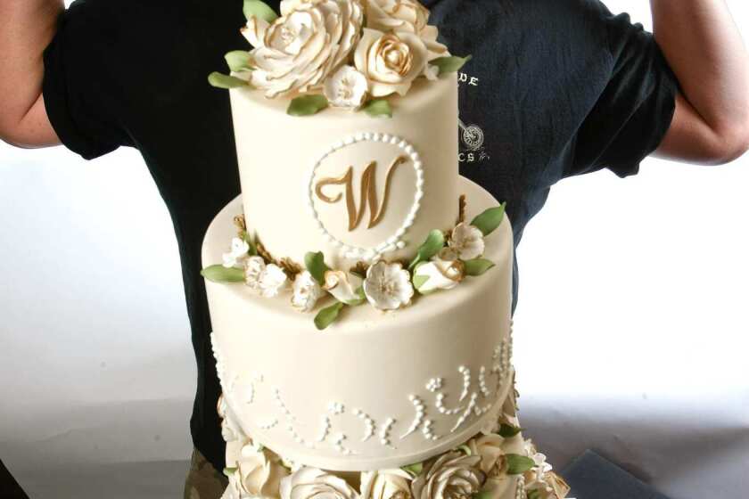 Duff Goldman, the cake baker behind the "Ace of Cakes" TV show, is photographed next to one of his designer cakes, a floral wedding cake at Charm City Cakes West, his new bakery in Los Angeles.