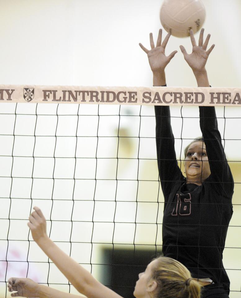 Flintridge Sacred Heart Academy's Natalie Buntich stretches to block a San Clemete hit during a CIF playoff match on Tuesday, Oct. 10, 2015.