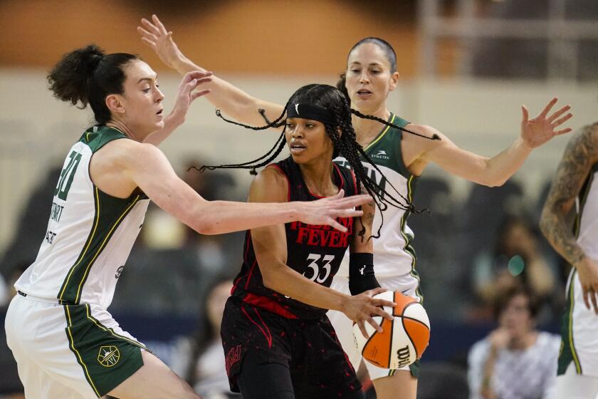 Seattle Storm forward Breanna Stewart (30) and guard Sue Bird (10) attempt to trap Indiana Fever guard Destanni Henderson (33) in the first half of a WNBA basketball game in Indianapolis, Tuesday, July 5, 2022. (AP Photo/Michael Conroy)