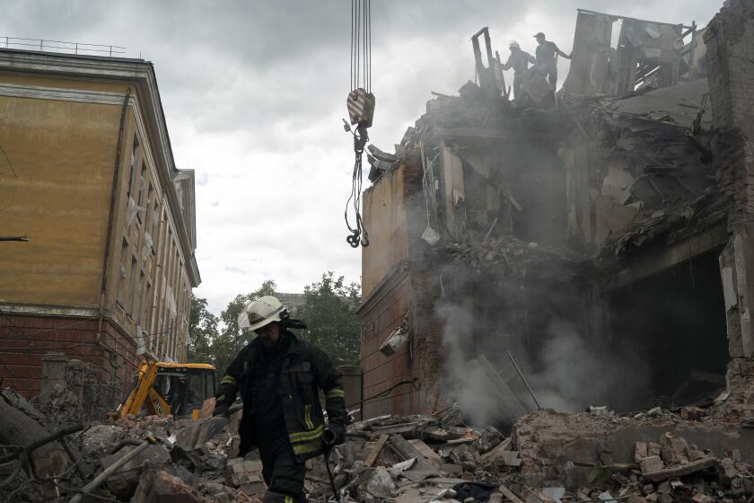 Firefighters work to extinguish a fire, looking for potential victims after a Russian attack that heavily damaged a residential building in Sloviansk, Ukraine, Wednesday, Sept. 7, 2022. (AP Photo/Leo Correa)