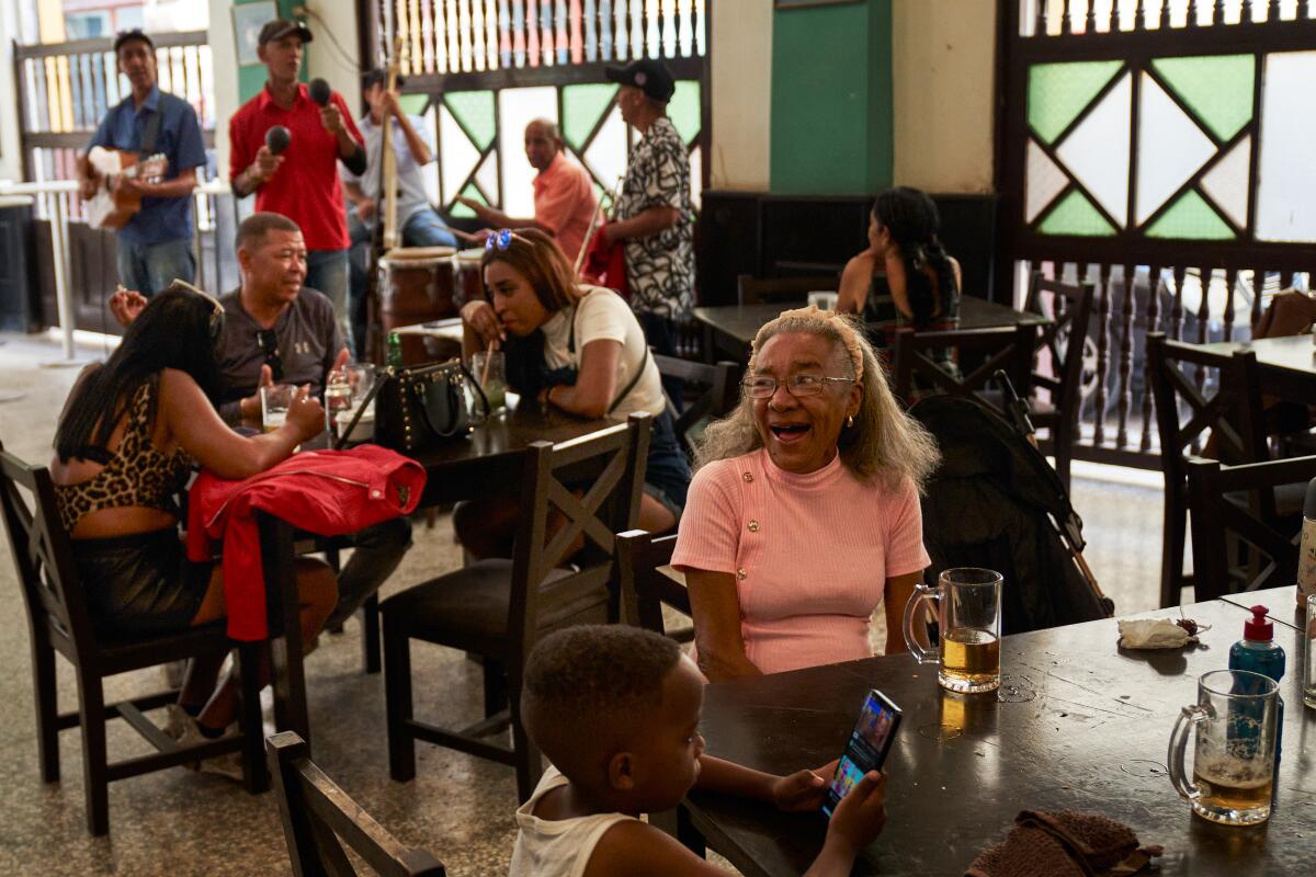 A woman reacts to her granddaughter at a bar
