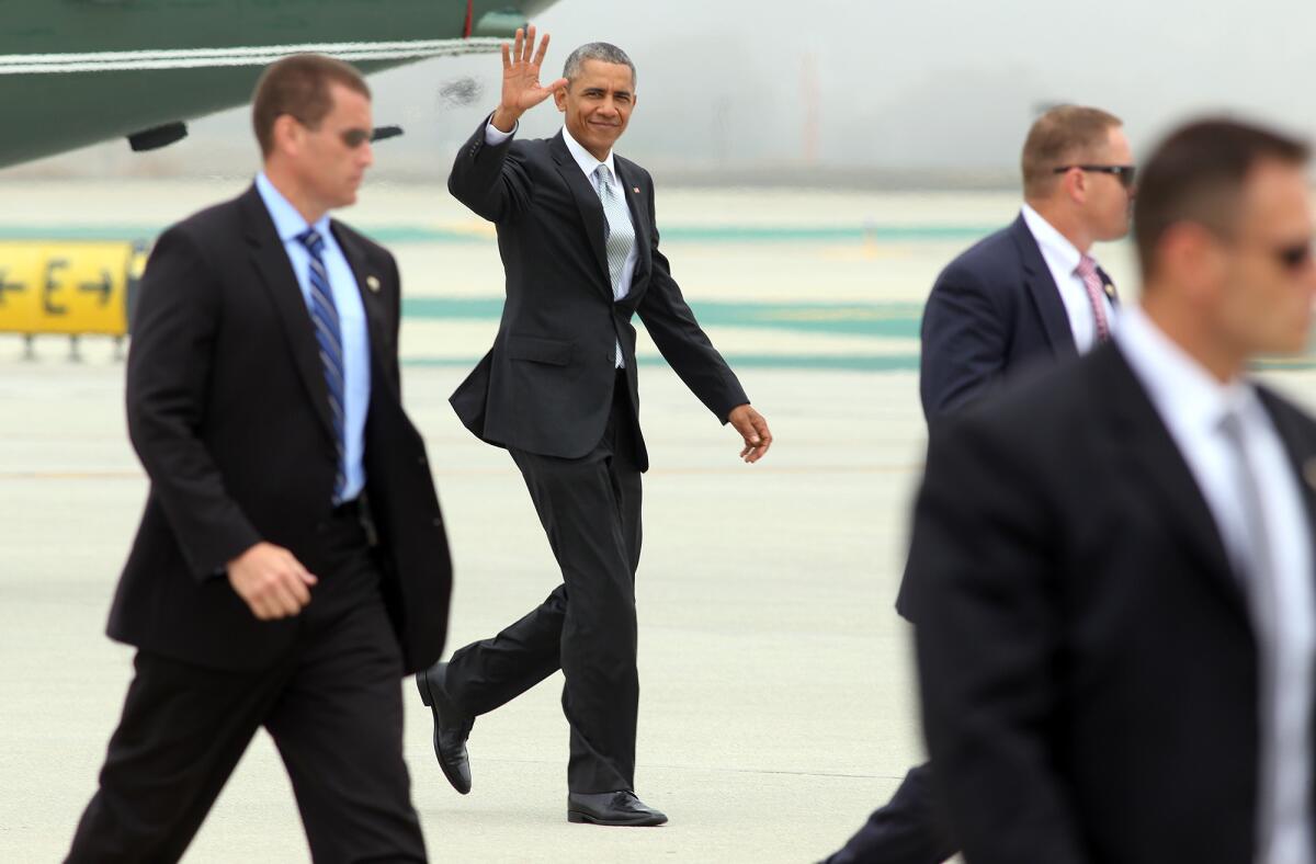 President Obama waves as he departs from Los Angeles International Airport after attending a pair of Democratic National Committee fundraisers in Los Angeles.