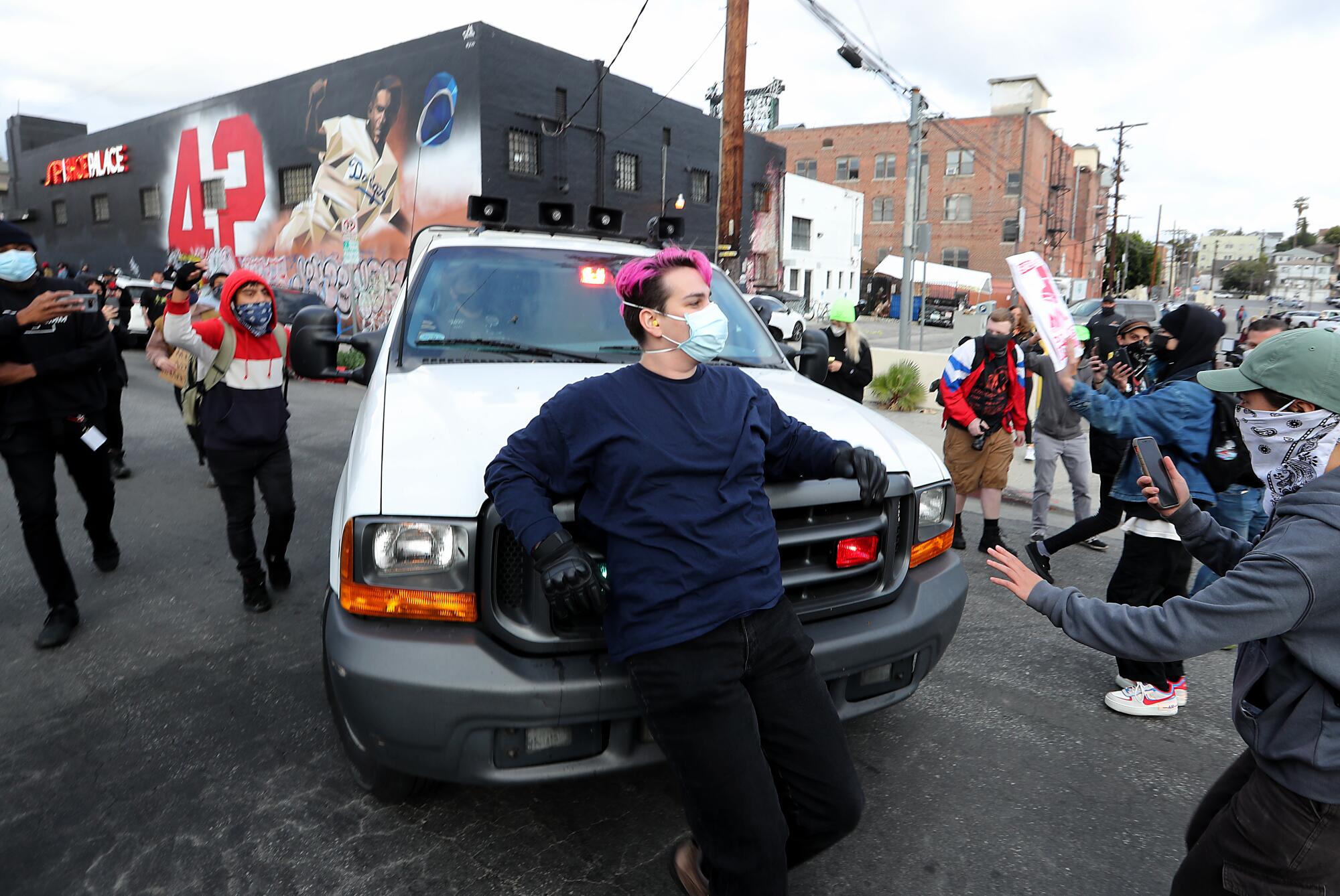 Protesters try to block a police vehicle.