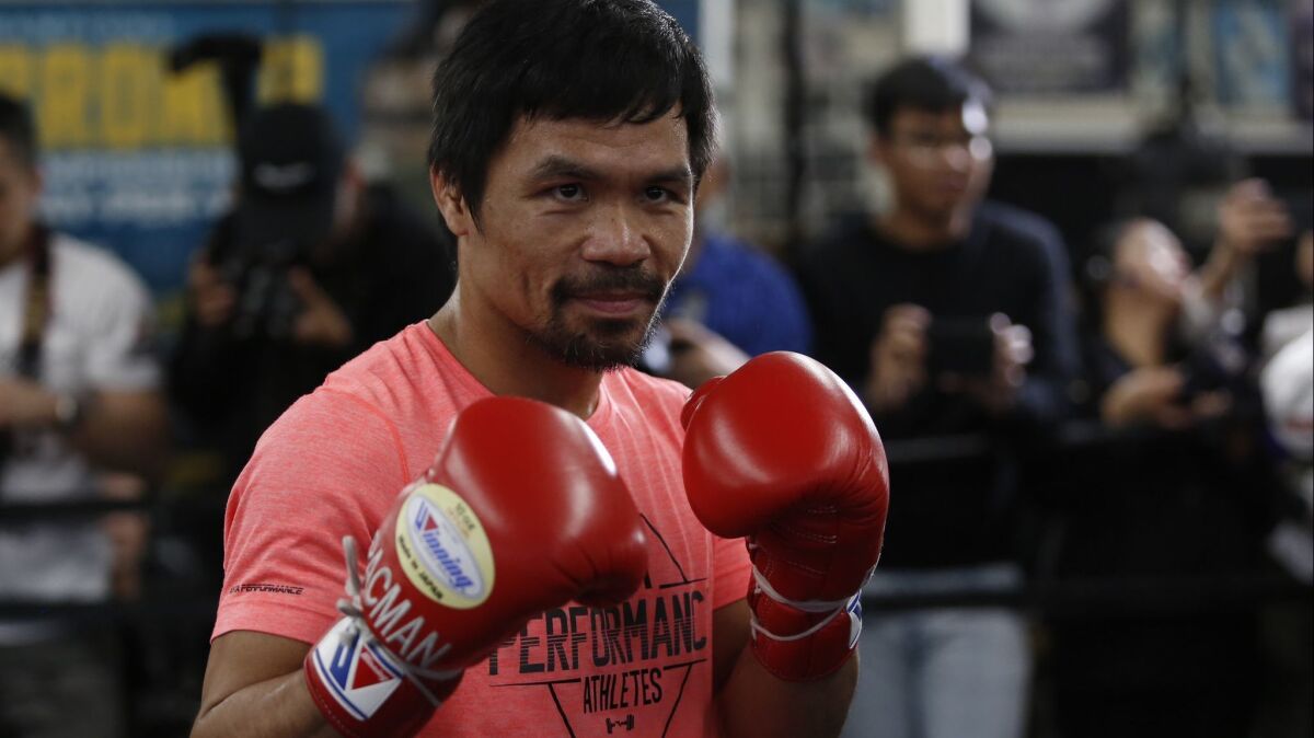 Manny Pacquiao poses for photos at a boxing club in Los Angeles on Wednesday.