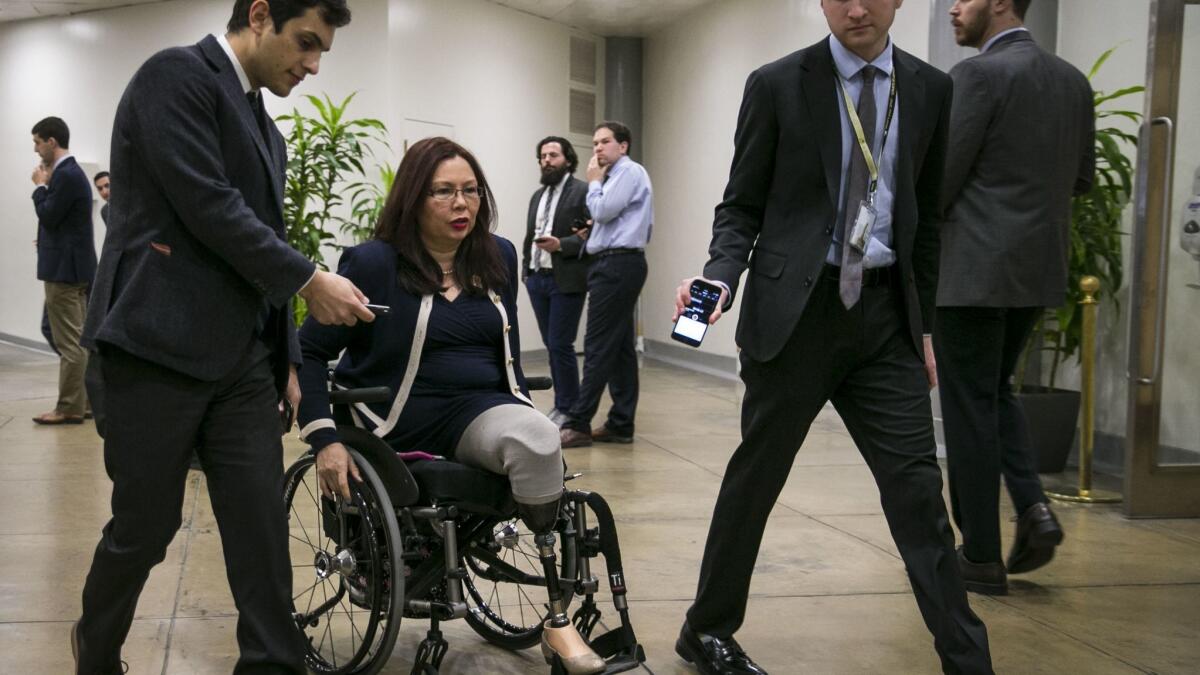 U.S. Sen. Tammy Duckworth (D-Ill.) speaks with reporters as she arrives for a weekly policy luncheon on Dec. 12, 2017, in Washington, D.C. She has pushed for legislation to require airlines to report data on lost or damaged wheelchairs and mobility scooters.