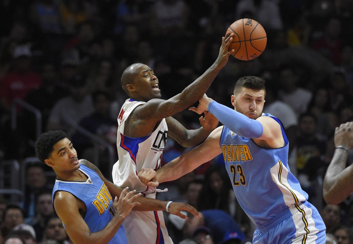 Clippers guard Jamal Crawford tries to pass as Nuggets guard Gary Harris, left, and center Jusuf Nurkic defend during a game at Staples Center on March 27.