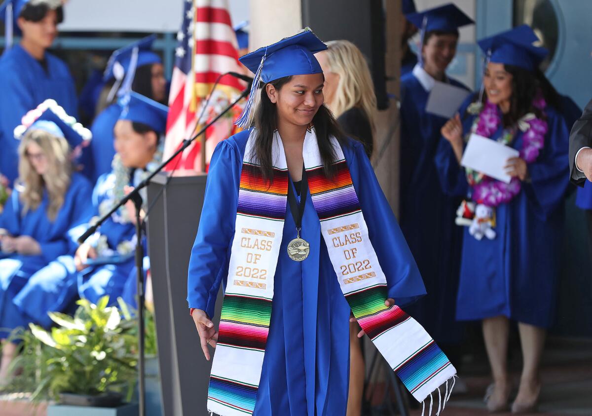 Wearing a colorful class of 2022 stole, Grecia Soto walks up to get her diploma during the Valley Vista High graduation.
