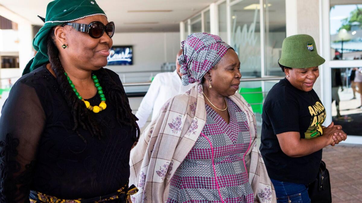 African National Congress executive committee member Nocawe Mafu, left, and ANC leadership candidate Nkosazana Dlamini-Zuma, center, arrive for a meeting on Dec. 14, 2017, ahead of the party's national conference in Johannesburg.