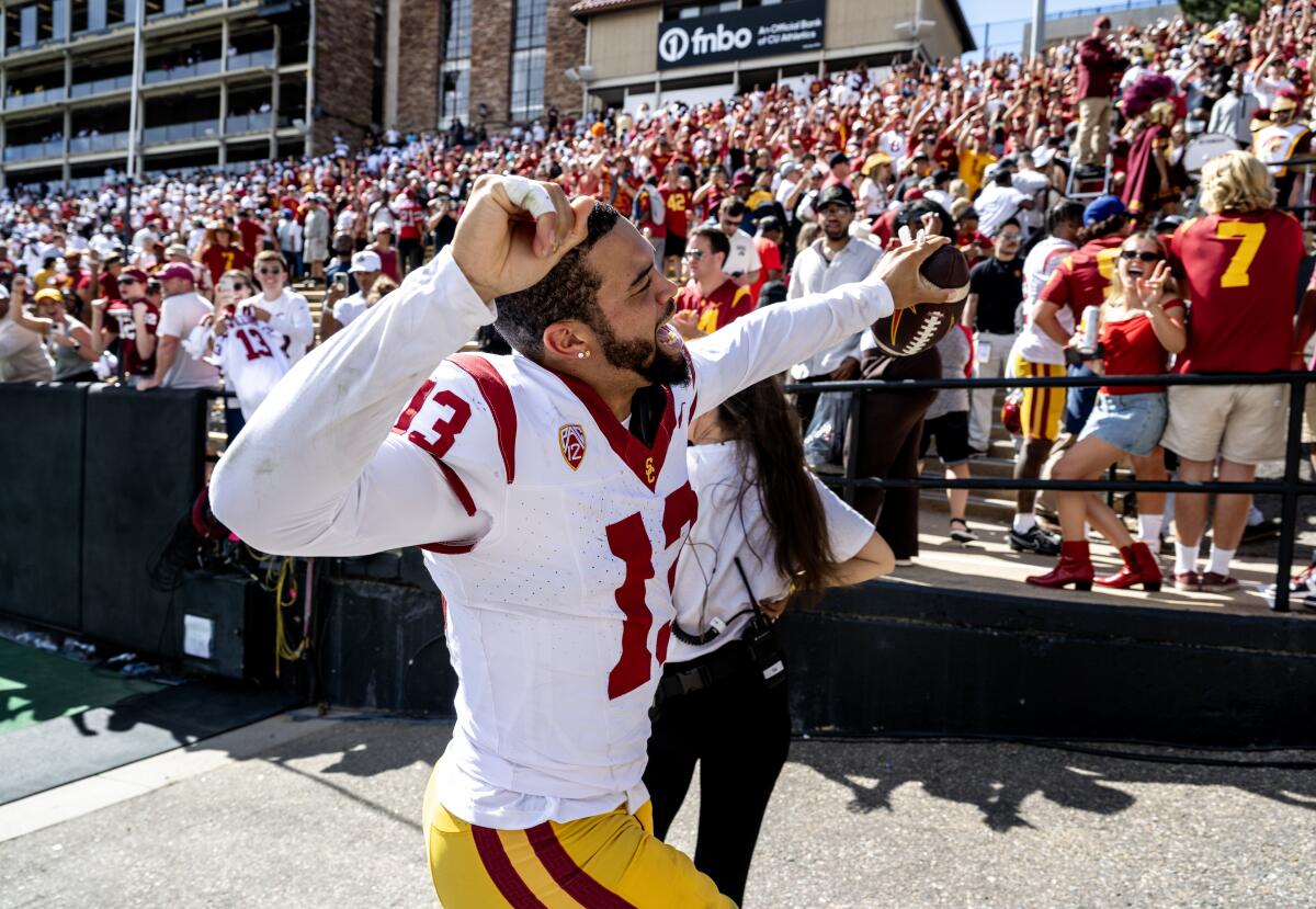 USC quarterback Caleb Williams celebrates and acknowledges Trojans fans during a 48-41 victory over Colorado.