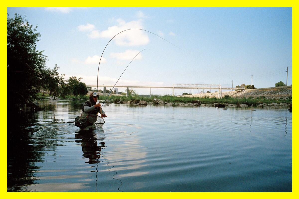 A man casts into the L.A. River using a fly-fishing rod. 