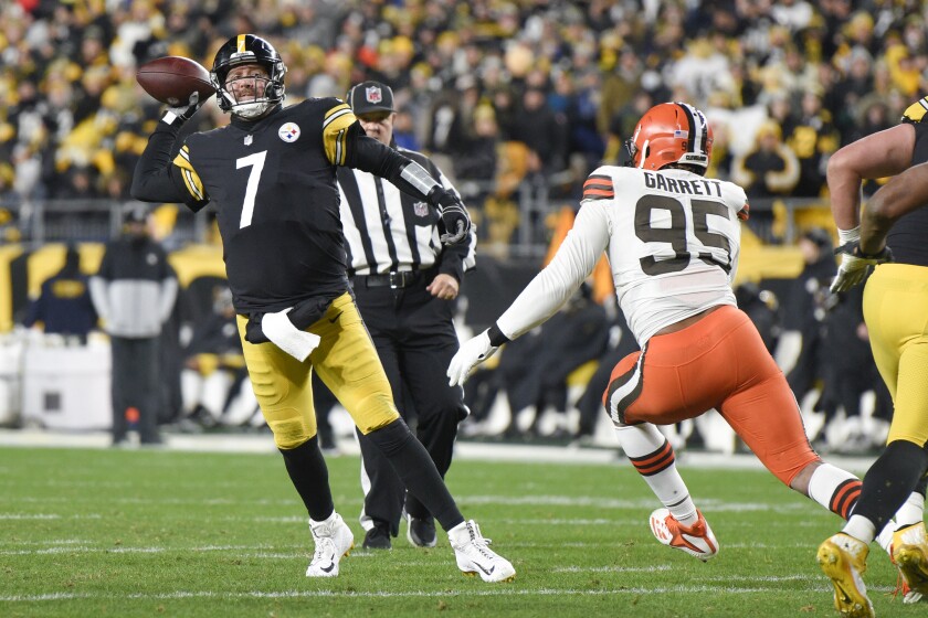Pittsburgh Steelers quarterback Ben Roethlisberger (7) gets a pass away as Cleveland Browns defensive end Myles Garrett (95) pressures him in the first half of an NFL football game, Monday, Jan. 3, 2022, in Pittsburgh. (AP Photo/Don Wright)