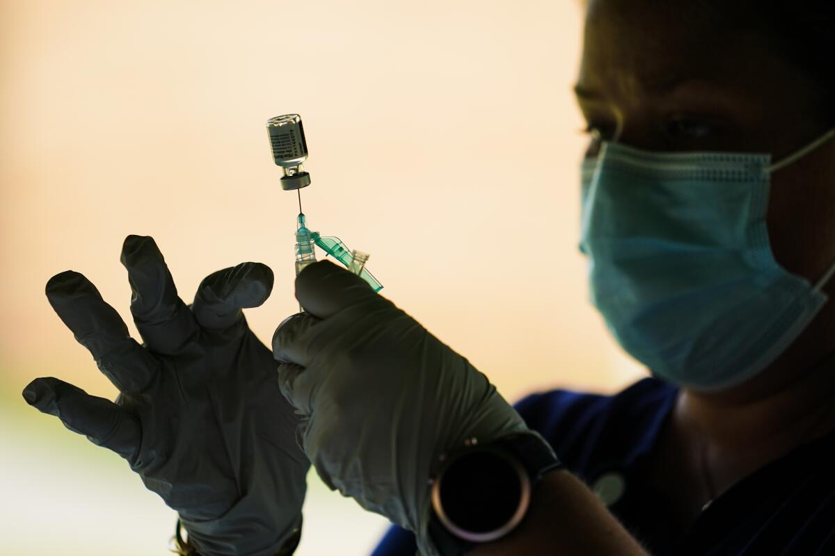 Una trabajadora de salud prepara una jeringa con la vacuna de Pfizer para el COVID-19