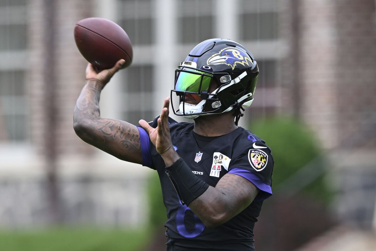 Baltimore Ravens quarterback Lamar Jackson takes part in drills at the NFL football team's practice facility, Tuesday, June 14, 2022, in Owings Mills, Md. (AP Photo/Gail Burton)