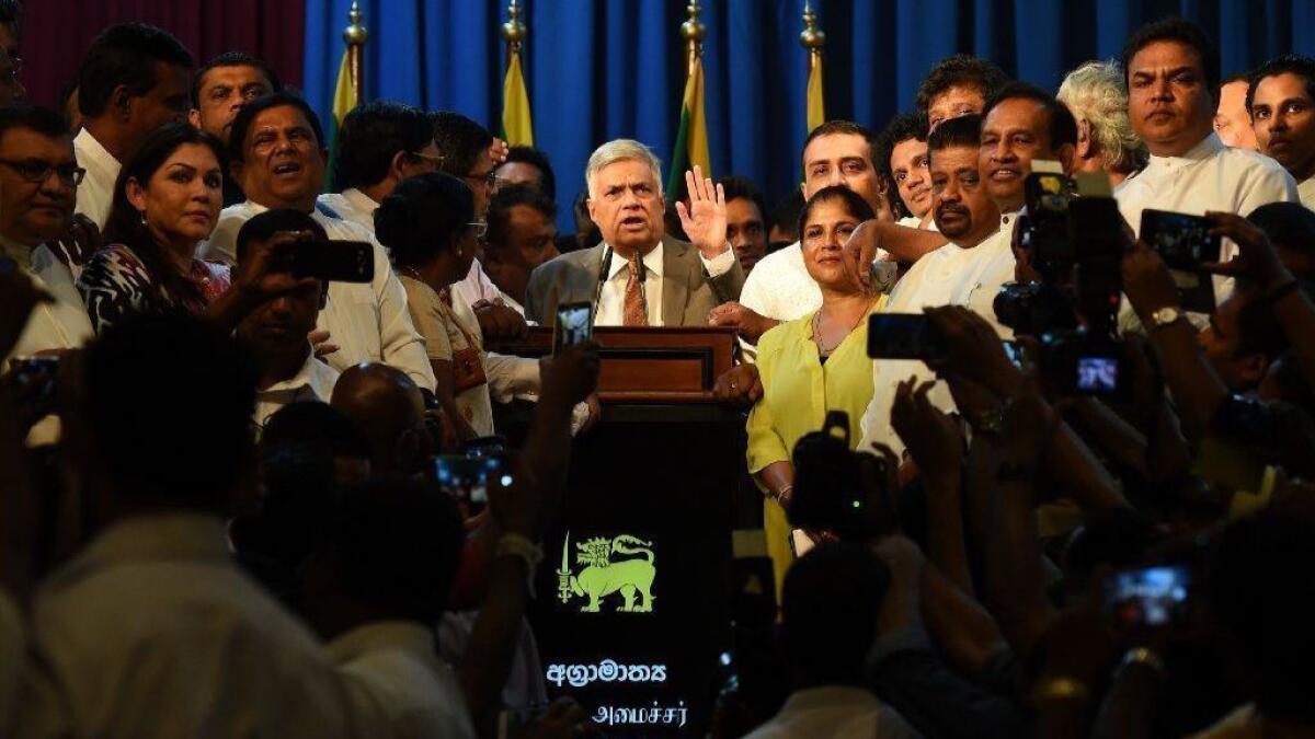 Sri Lankan Prime Minister Ranil Wickremesinghe speaks to supporters at his official residence in Colombo on Sunday after taking the oath of office.