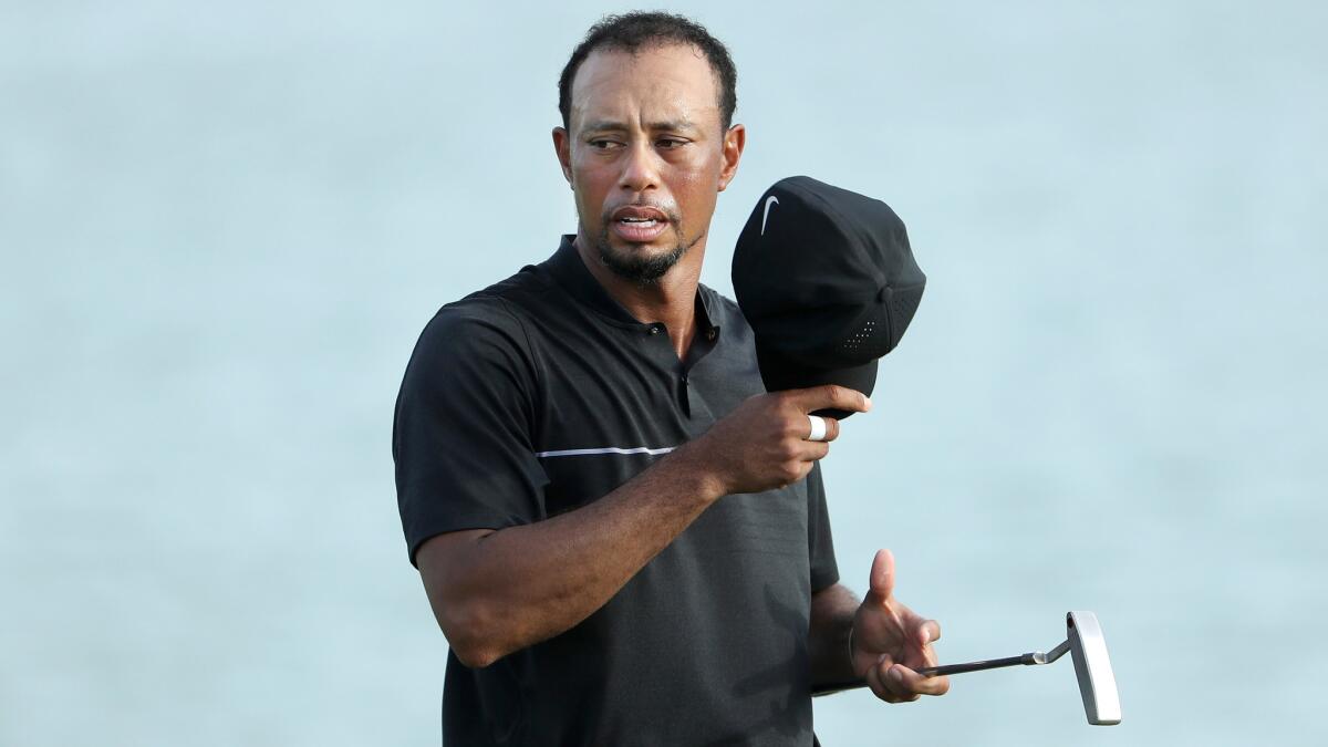 Tiger Woods prepares to putt at No. 18 during the first round of the Hero World Challenge on Thursday.
