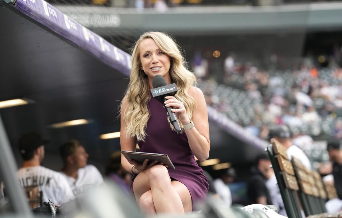 Colorado Rockies television reporter Kelsey Wingert does a spot from the first-base well before the first inning of a game against the San Francisco Giants Monday, May 16, 2022, in Denver. Wingert was hit by a foul off the bat of San Francisco Giants' Austin Slater in the ninth inning of the game. The announcer, who was seated in the first-base camera well, was taken from the game after being struck in the head by the ball. (AP Photo/David Zalubowski)