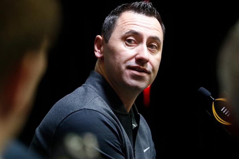 Steve Sarkisian listens to a question during a media session for the College Football Playoff championship game.