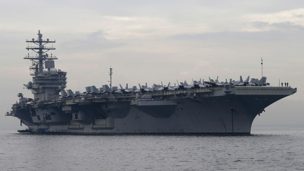 The U.S. aircraft carrier Ronald Reagan anchors off Manila on June 26.