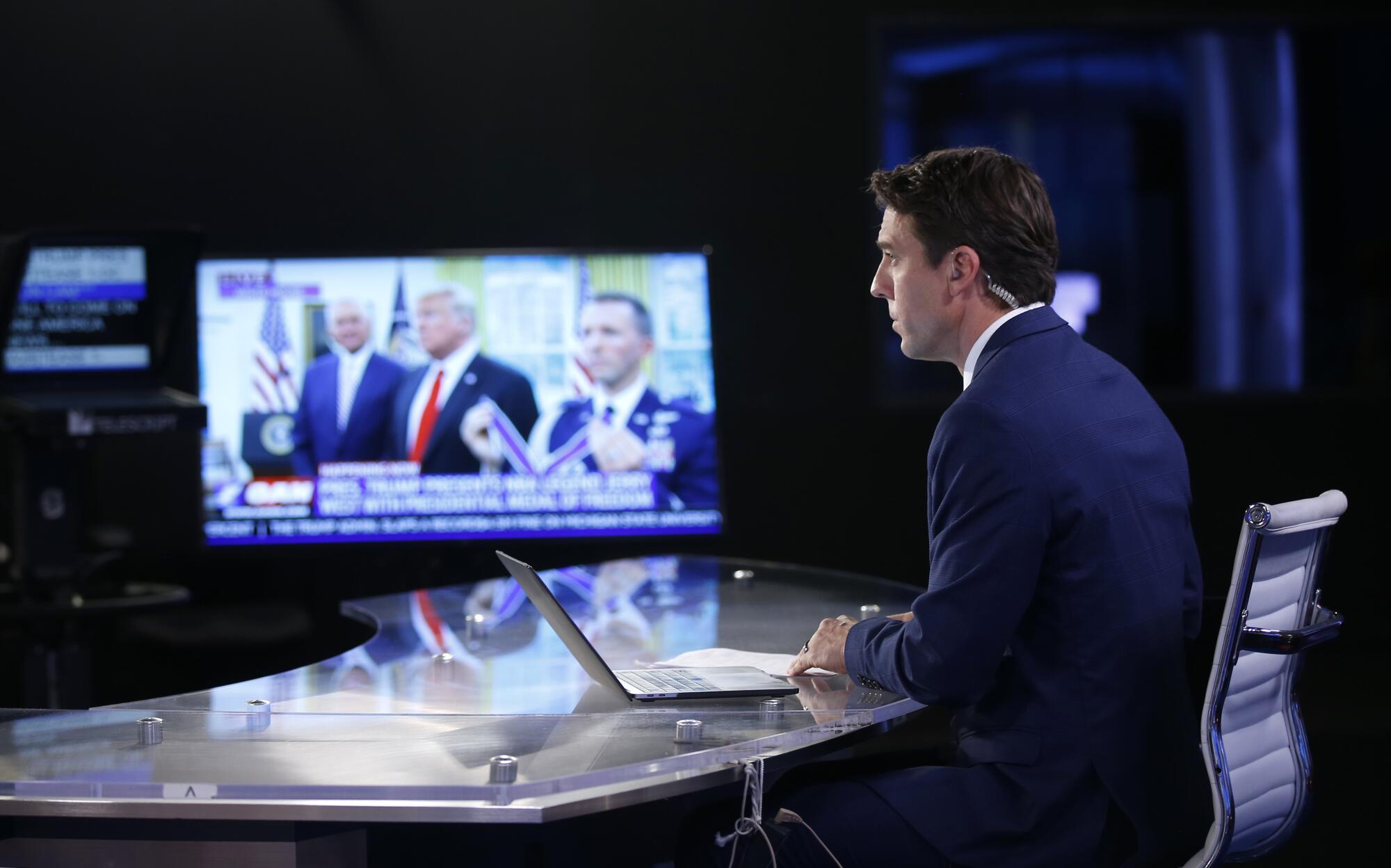 Patrick Hussion waits to go back on the air while hosting an evening news segment at One America News on Sept. 5, 2019.