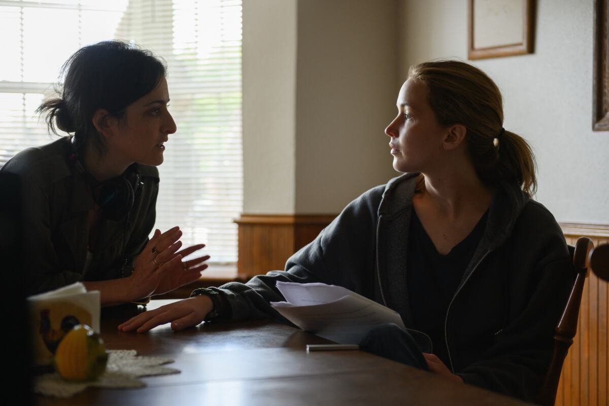 Two women sitting at a table talking to each other