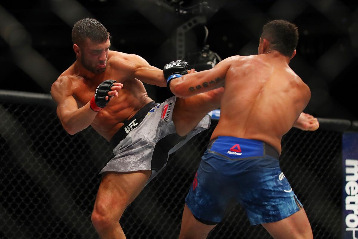 David Teymur attempts to kick Drakkar Klose as they trade blow during their fight at UFC 218.
