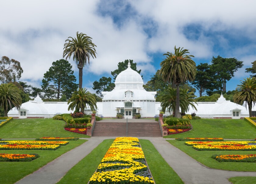 The white building called the Conservatory of Flowers is seen.