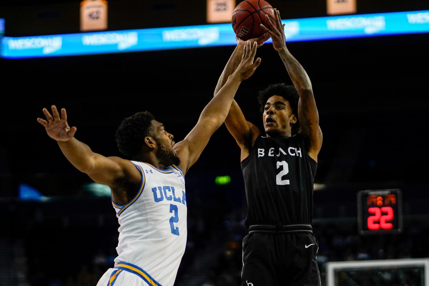 Long Beach State guard Jordan Roberts (2) shoots while being defended by UCLA forward Cody Riley (2) during the first half of a game Nov. 6 at Pauley Pavilion.