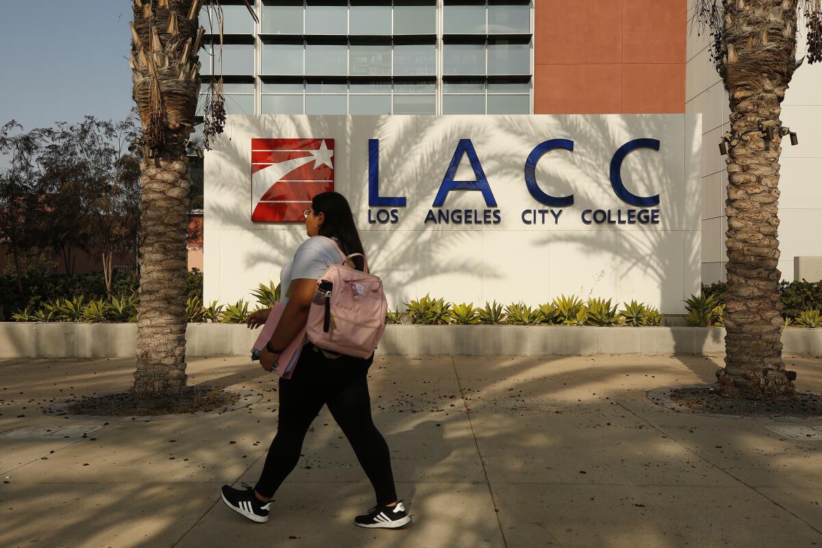 A person with a backpack walks near LACC.
