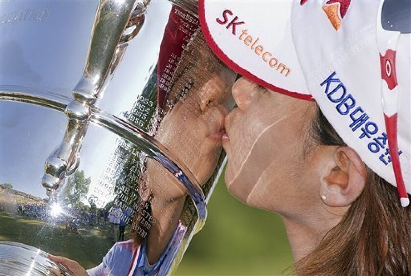 South Korea's Na Yeon Choi kisses the championship trophy after winning the U.S. Women's Open golf tournament, Sunday, July 8, 2012, in Kohler, Wis. (AP Photo/Julie Jacobson)