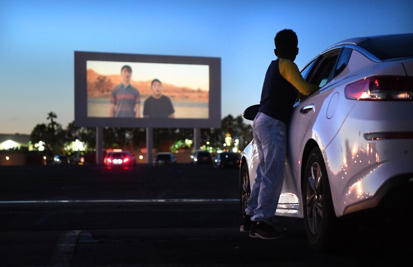 Michael Ray, 11, watches a trailer before a movie at the Paramount Drive-In 