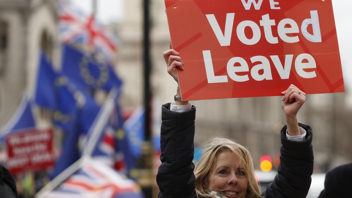 A pro-Brexit demonstrator waves a placard outside the Houses of Parliament in London on Dec. 18.