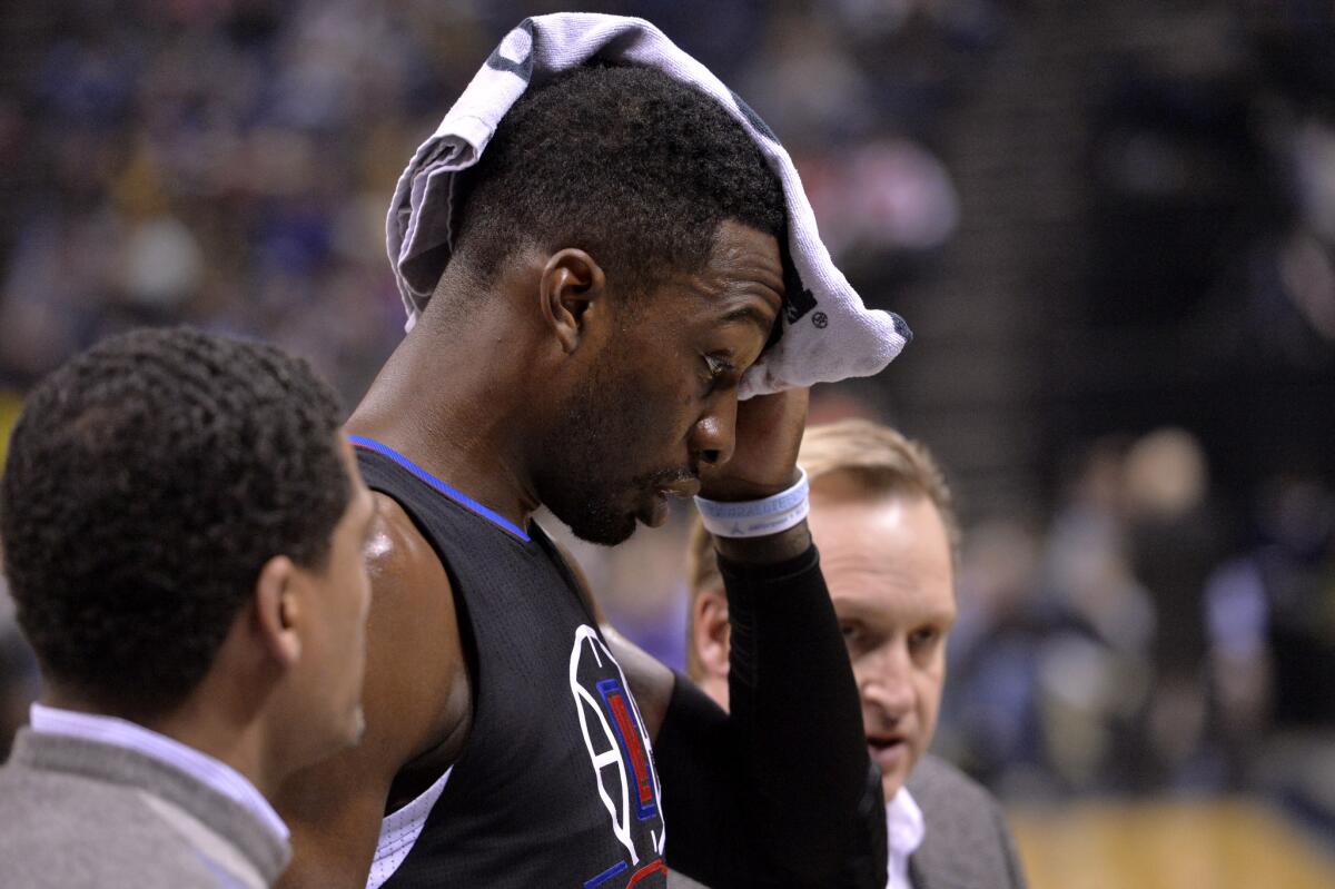 Clippers forward Jeff Green is helped off the court after suffering a head laceration Saturday against Memphis that required eight stitches.