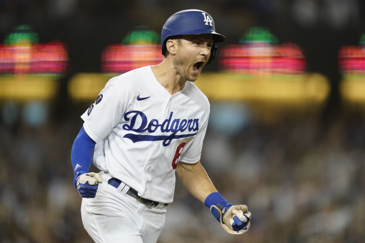 Los Angeles Dodgers' Trea Turner reacts as he runs the bases after hitting a grand slam home run during the fifth inning of a baseball game against the Milwaukee Brewers Friday, Sept. 1, 2021, in Los Angeles. Austin Barnes, Albert Pujols, and Mookie Betts also scored. (AP Photo/Ashley Landis)