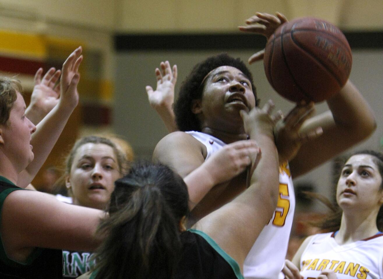 La Cañada High School girls basketball player #45 Zoe Williams get hammered as she goes up for a basket in the paint in championship game vs. Thousand Oaks High School in the La Cañada High School New Year's Eve tournament at home in La Cañada Flintridge on Thursday, Dec. 29, 2016.