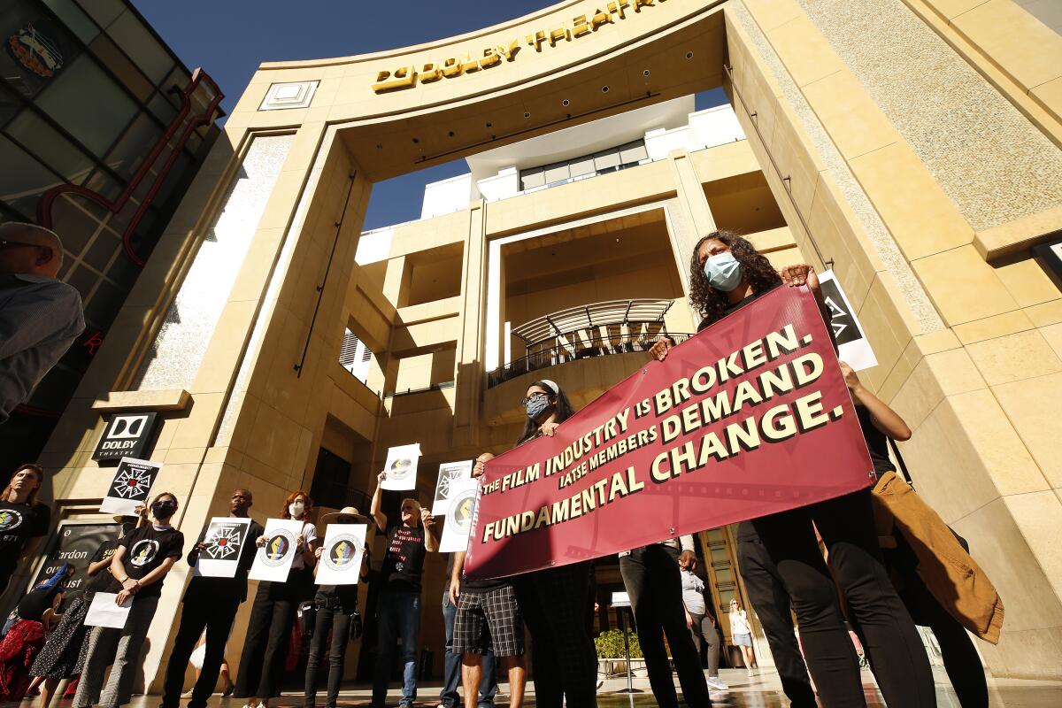 Union members and supporters hold signs in front of Hollywood's Dolby Theatre. 
