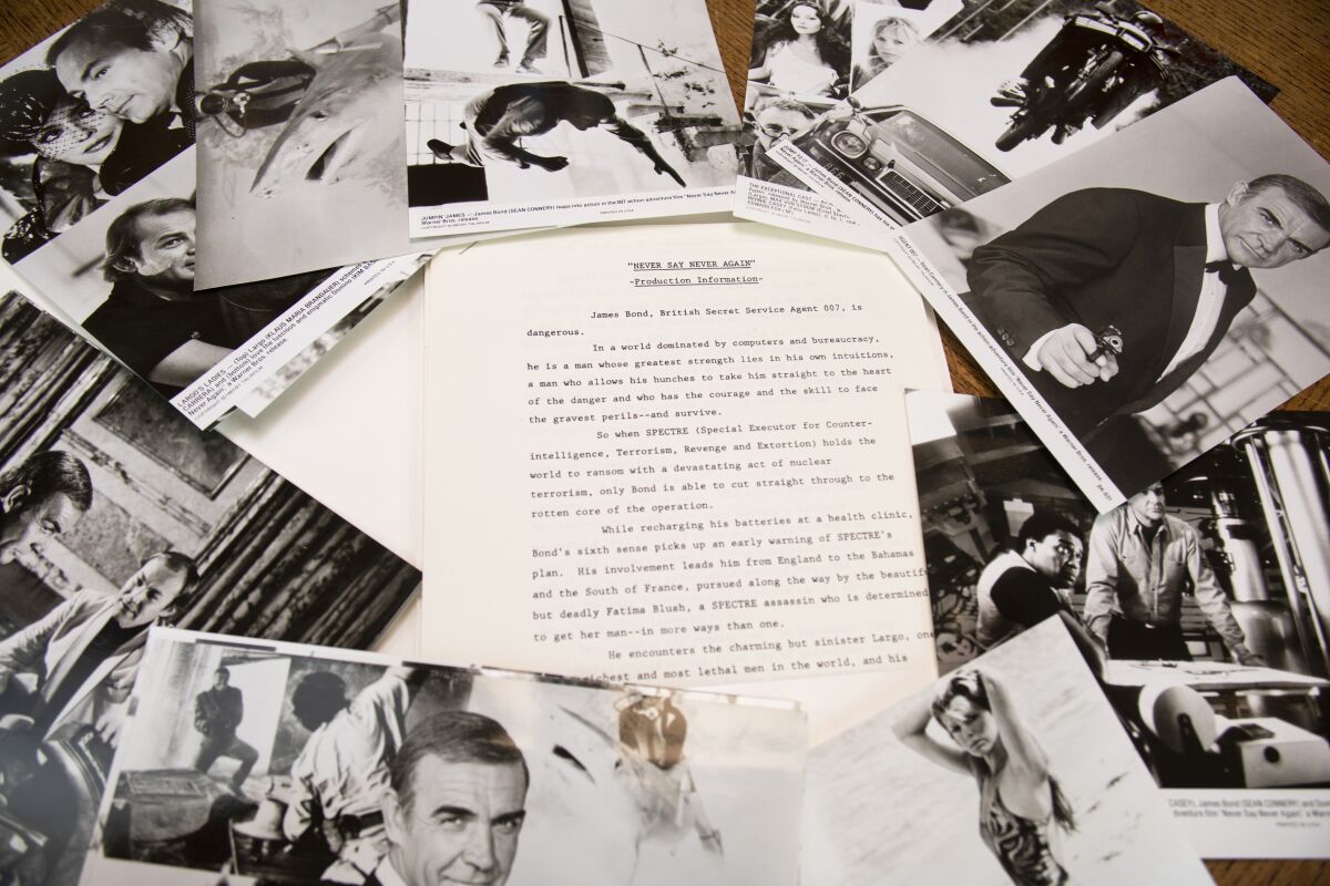 black and white photos, surrounding a piece of paper at the center.