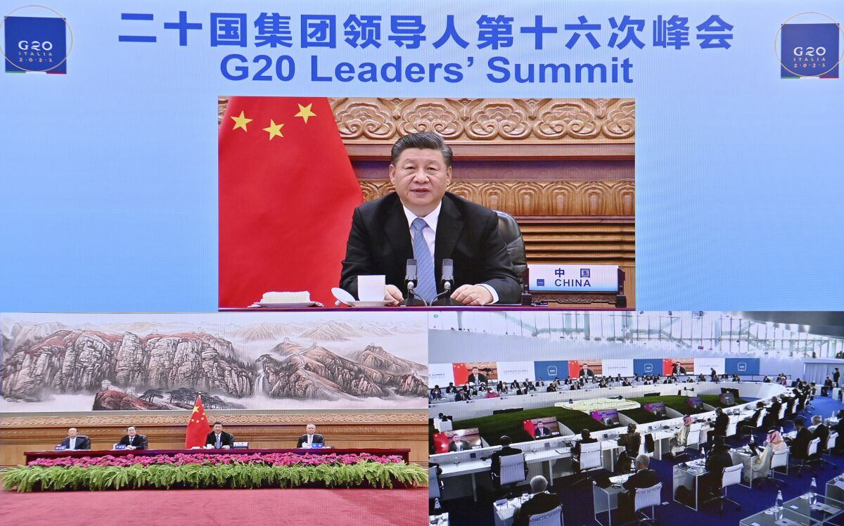 In this photo released by China's Xinhua News Agency, Chinese President Xi Jinping speaks via video link to leaders at the G20 Summit from Beijing, Sunday, Oct. 31, 2021. President Xi has been absent from the Group of 20 summit in Rome and global climate talks in Scotland, drawing criticism from U.S. President Joe Biden and questions about China's commitment to reducing greenhouse gas emissions. (Yue Yuewei/Xinhua via AP)
