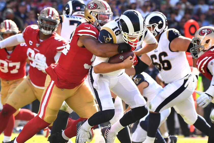 LOS ANGELES, CALIFORNIA OCTOBER 13, 2019-Rams Jared Goff is sacked by 49ers defensive lineman Solomon Thomas in the 3rd quarter at the Coliseum Sunday. (Wally Skalij/Los Angeles Times)
