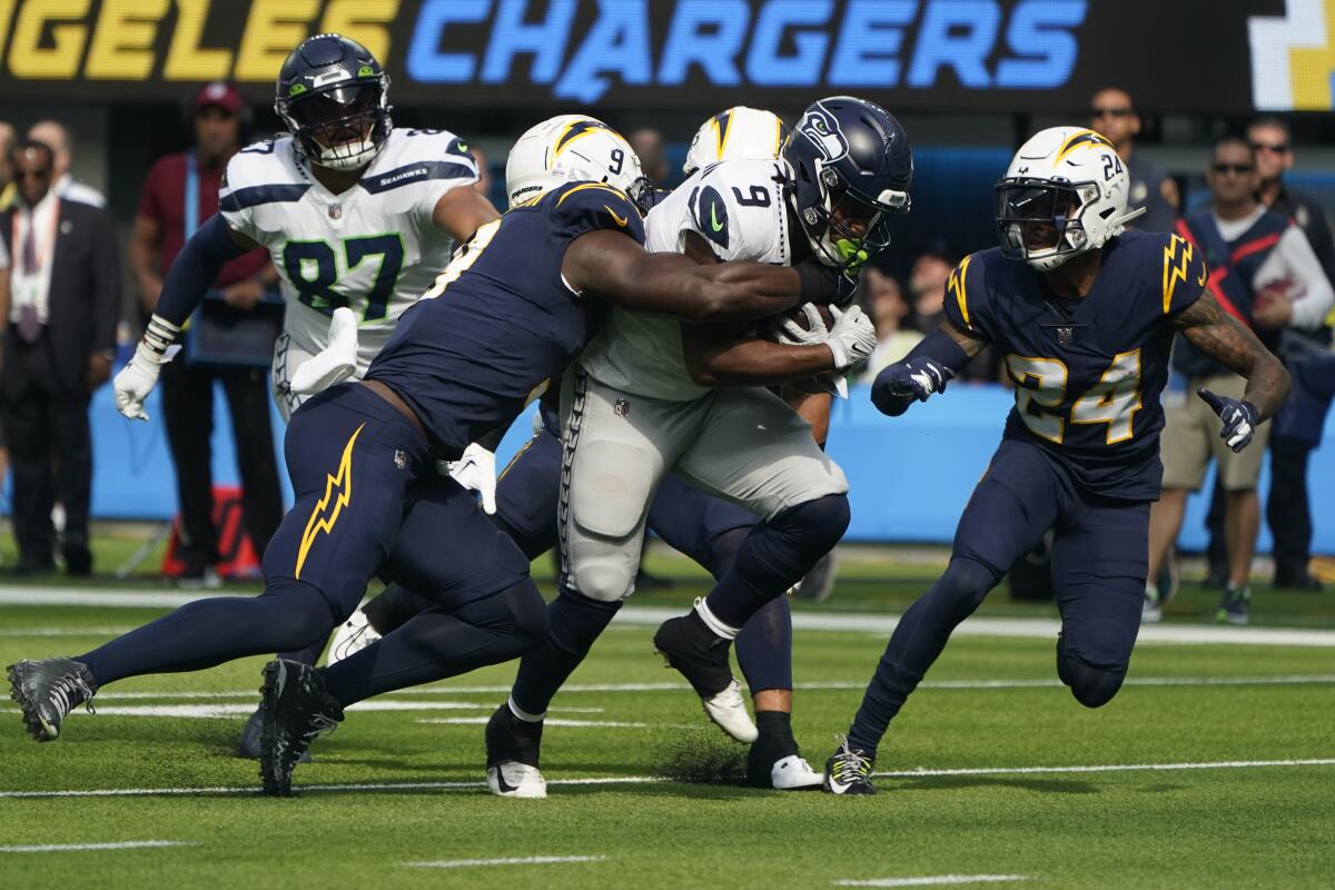 Seattle Seahawks running back Kenneth Walker III carries the ball against the Chargers in the first half.