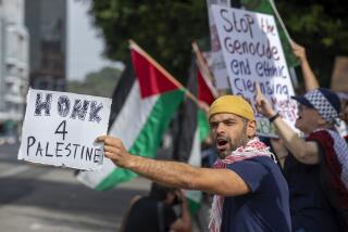 LOS ANGELES, CA-NOVEMBER 4, 2023, 2023:Ameen Bedouin, 34, left, joins other protesters, demanding an end to the Israeli invasion of Gaza during a pro-Palestinian rally outside the Israeli Consulate on Wilshire Blvd. in Los Angeles. (Mel Melcon / Los Angeles Times)
