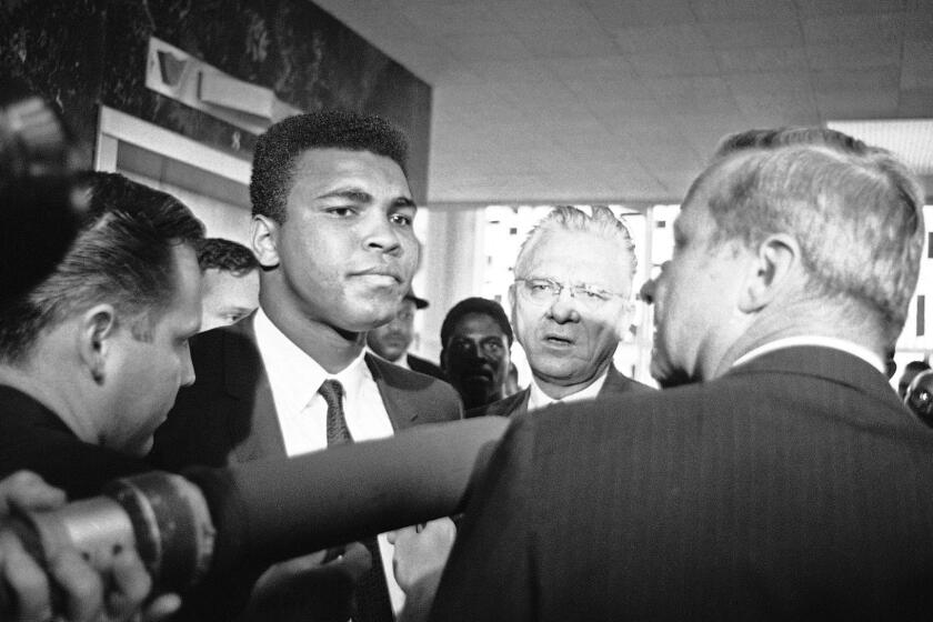Muhammad Ali with his chief attorney Hayden Covington, right, on June 19, 1967, in Houston, as the boxing champion goes to trial on charges of refusing to be inducted into the armed services.