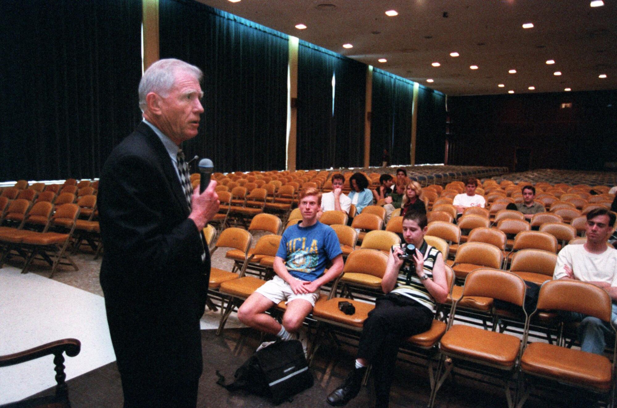 UCLA Chancellor Charles E. Young talks to a handful of students in town hall meeting.