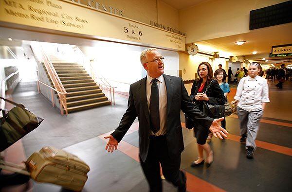 Metrolink Chief Executive John E. Fenton walks with passengers after arriving at Union Station on a train he had boarded in Pomona after leading the early morning meeting of his command staff. Things have improved dramatically at the agency since he took over in April 2010. See full story