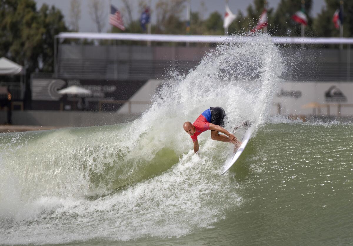 Surfing legend Kelly Slater throws spray as he turns off the top of a wave during practice with Team U.S.A. at his Surf Ranch, which boasts man-made waves in the Central Valley farm town of Lemoore, Calif.