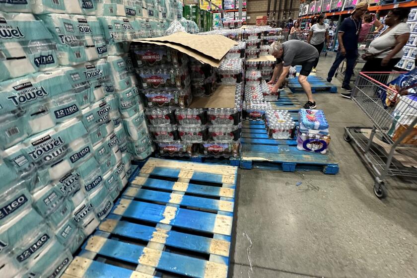 People load cases of bottled water as customers buy emergency supplies ahead of Hurricane Hilary at a Costco warehouse in Hawthorne, California on August 19, 2023. Hilary continued on a steady path toward Mexico's Baja California peninsula on August 19 as a powerful hurricane that officials warned could bring "potentially catastrophic" flooding there and to parts of the US Southwest. The storm weakened from a powerful Category 4 to Category 3, but still deemed capable of "devastating damage," the US National Hurricane Center (NHC) said. (Photo by Patrick T. FALLON / AFP) / "The erroneous byline appearing in the metadata of this photo has been modified in AFP systems in the following manner: [Patrick T. FALLON] instead of [David SWANSON]. Please immediately remove the erroneous mention from all your online services and delete it from your servers. If you have been authorized by AFP to distribute it to third parties, please ensure that the same actions are carried out by them. Failure to promptly comply with these instructions will entail liability on your part for any continued or post notification usage. Therefore we thank you very much for all your attention and prompt action. We are sorry for the inconvenience this notification may cause and remain at your disposal for any further information you may require." (Photo by PATRICK T. FALLON/AFP via Getty Images)