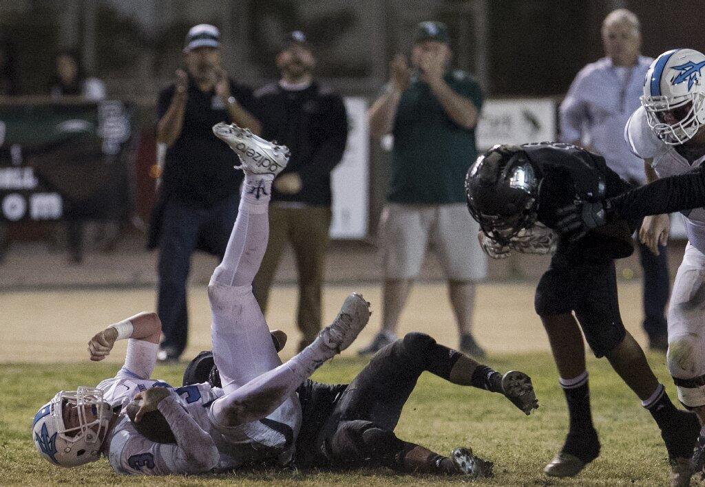 Corona del Mar High quarterback Chase Garbers is sacked by a Buena Park defender.