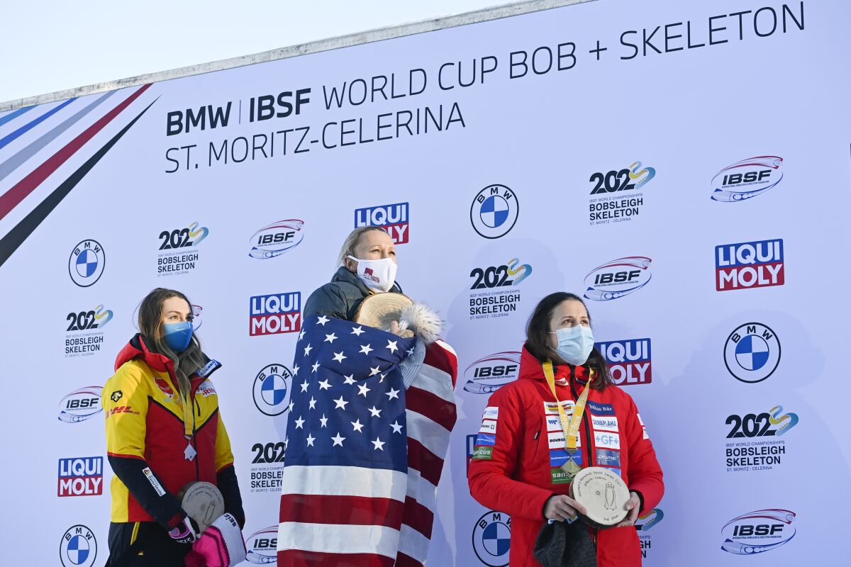 The podium with second placed Laura Nolte of Germany, winner Kaillie Humphries of USA and third placed Martina Fontanive of Switzerland, from left, after the women's monobob World Series in St. Moritz, Switzerland, on Saturday, January 16, 2021. (Gian Ehrenzeller/Keystone via AP)