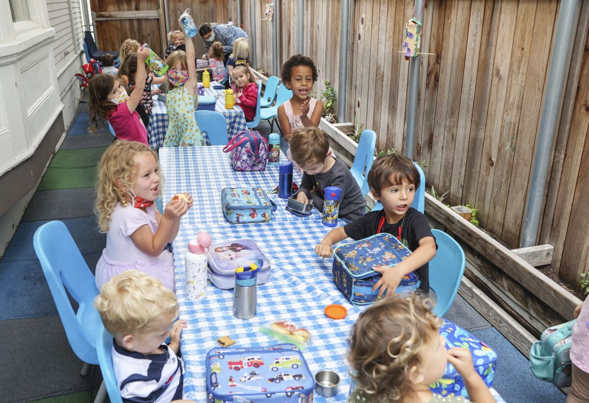 Students finish up a snack before playtime at La Petite Etoile 360 Preschool on Thursday, May 13, 2021 in San Diego, CA.