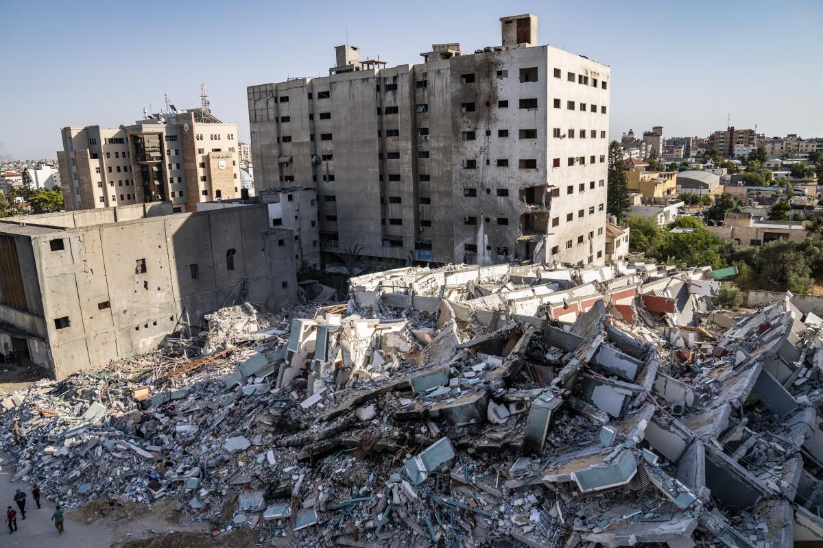 An overview of the rubble of a building, with other buildings in the background