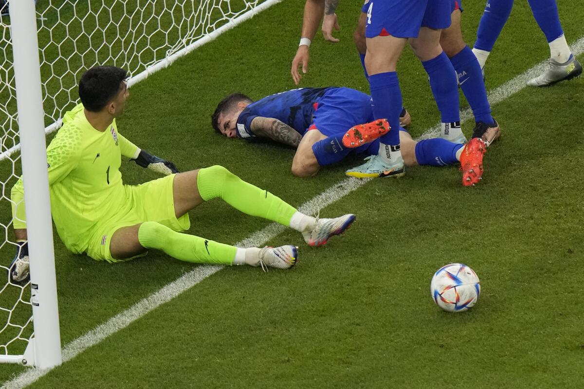 U.S. forward Christian Pulisic struggles to get up after scoring against Iran in the first half.